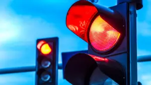 A stoplight shining red.